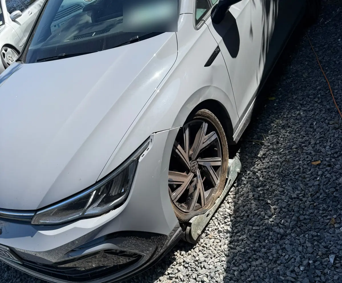 A car with a broken front wheel waiting for breakdown recovery, unable to be driven