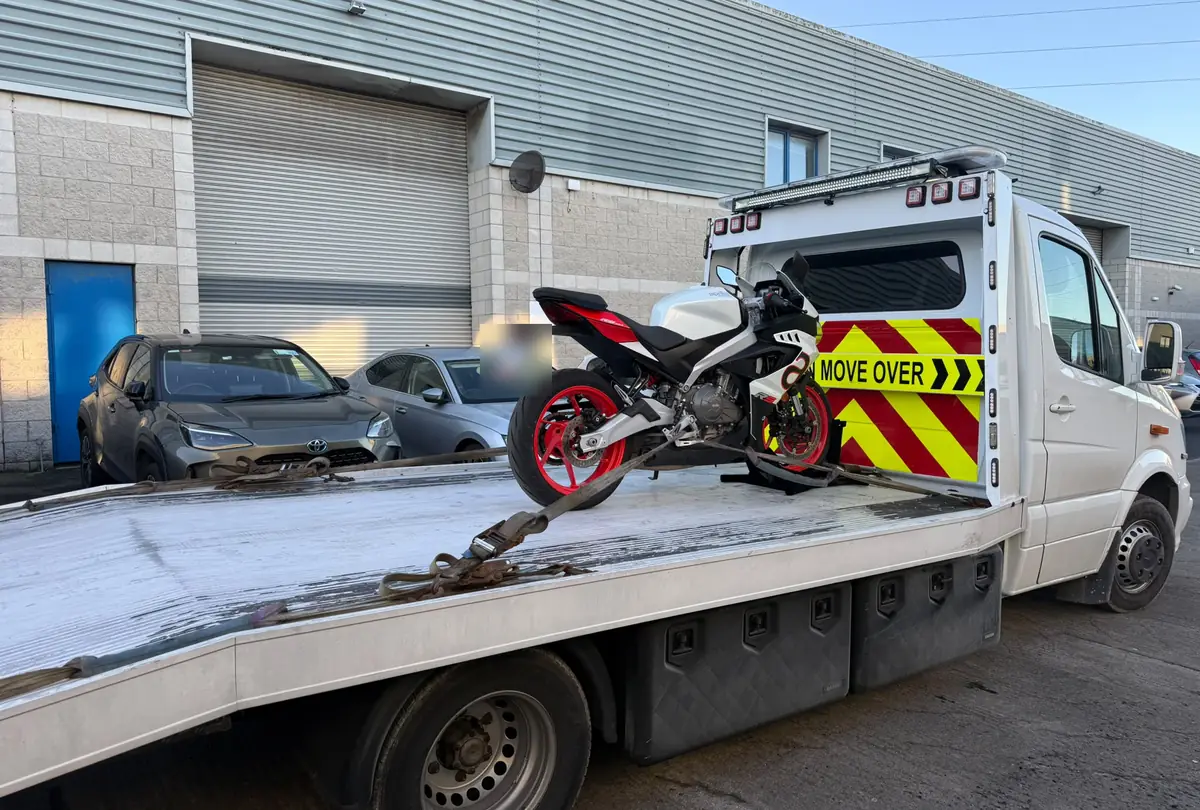 A motorbike strapped onto a flatbed recovery truck outside an industrial unit in Dublin