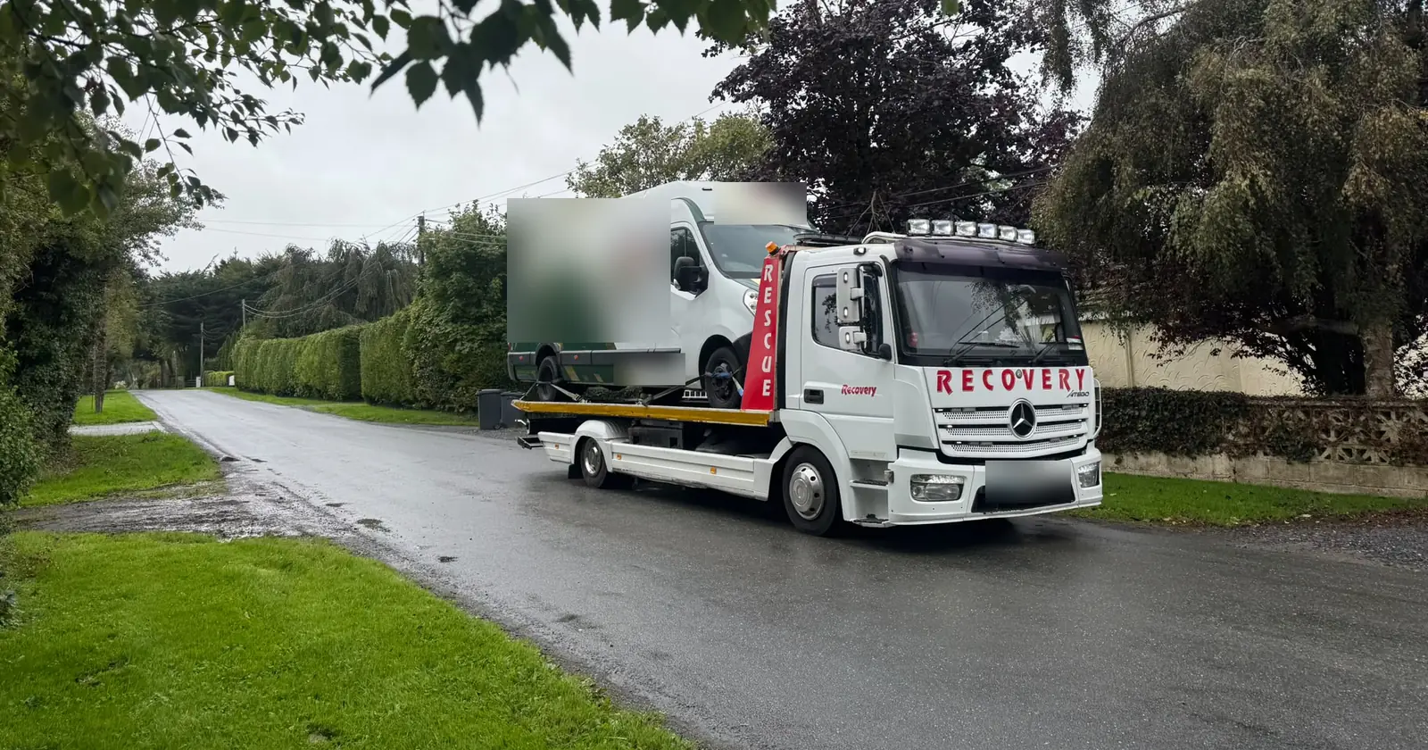 Recovery CC Mercedes tow truck carrying a van along a country road outside Dublin